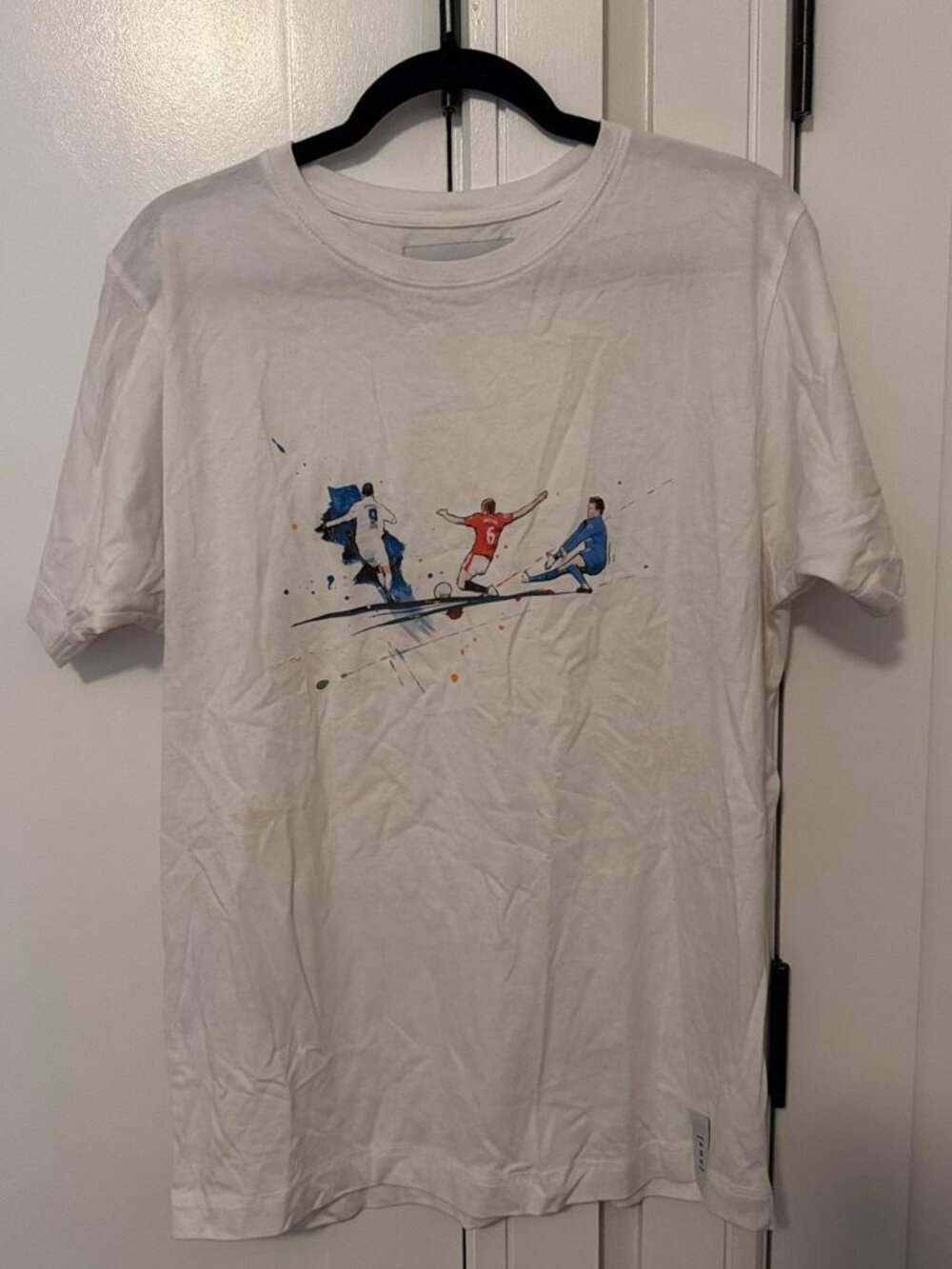 White soccer tee with three-player graphic
